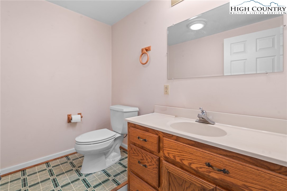 883 Bald Mountain Road West Jefferson, NC 28694 - Photo 22 of 47 a bathroom with a sink toilet and vanity