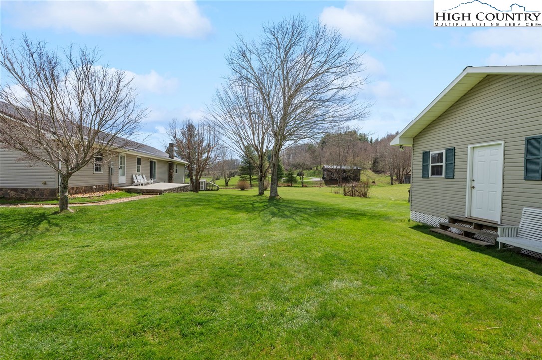 883 Bald Mountain Road West Jefferson, NC 28694 - Photo 34 of 47 a view of a yard with a house and garden
