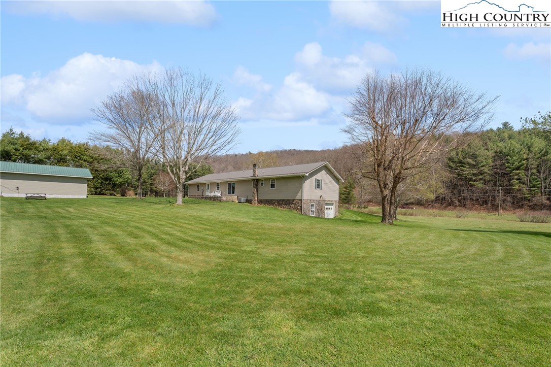 883 Bald Mountain Road West Jefferson, NC 28694 - Photo 36 of 47 a view of a big yard with potted plants and large tree