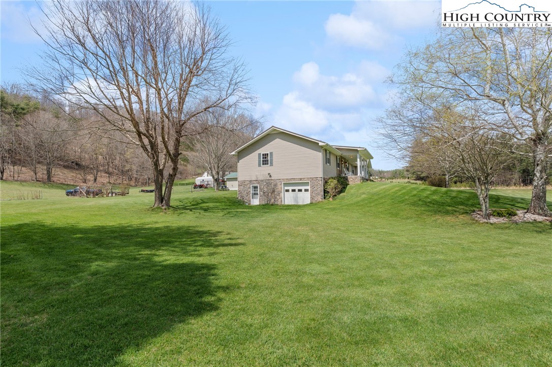 883 Bald Mountain Road West Jefferson, NC 28694 - Photo 37 of 47 a view of a house with a yard