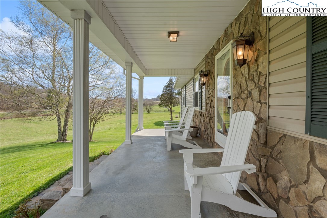883 Bald Mountain Road West Jefferson, NC 28694 - Photo 40 of 47 a view of a porch with chairs and floor to ceiling window