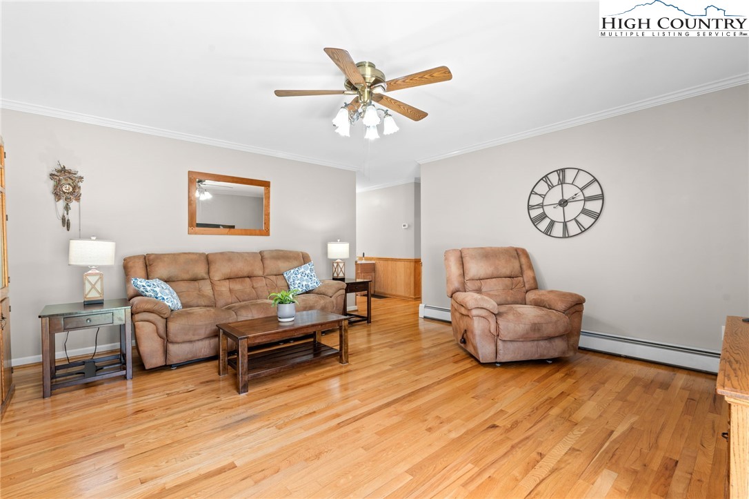 883 Bald Mountain Road West Jefferson, NC 28694 - Photo 4 of 47 a living room with furniture and a wooden floor