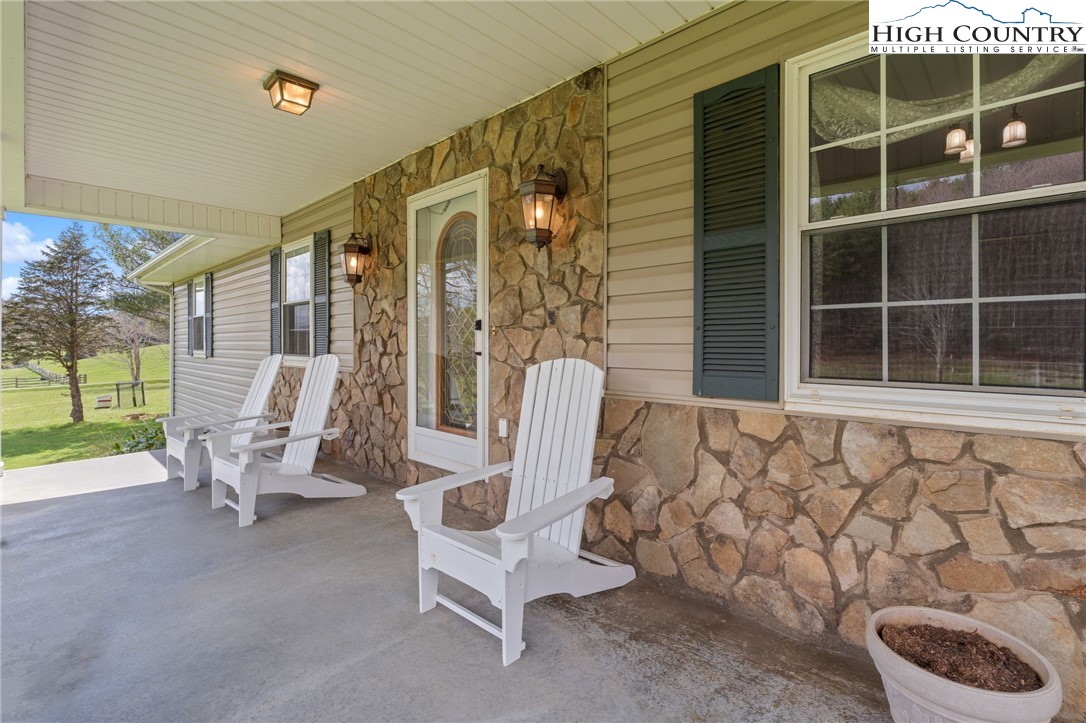 883 Bald Mountain Road West Jefferson, NC 28694 - Photo 42 of 47 a view of a chair and table in the back yard of the house