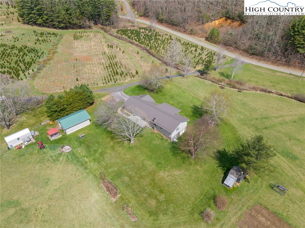 883 Bald Mountain Road West Jefferson, NC 28694 - Photo 46 of 47 a backyard of a house with lots of green space and garden