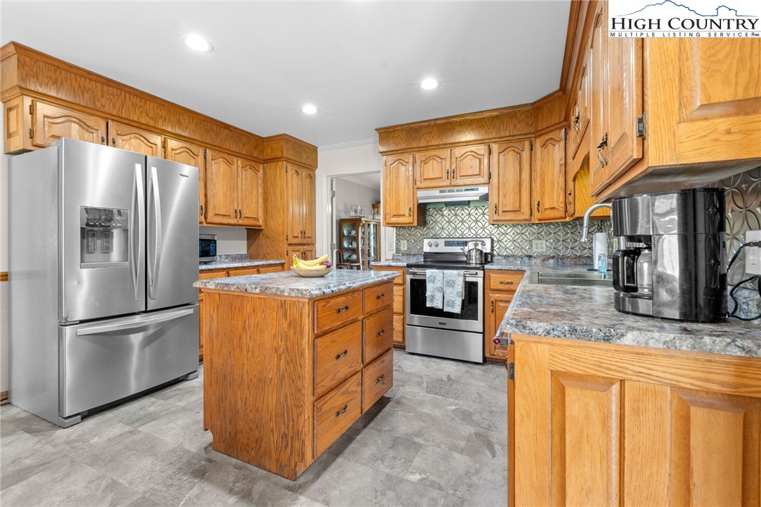883 Bald Mountain Road West Jefferson, NC 28694 - Photo 6 of 47 a kitchen with stainless steel appliances granite countertop a refrigerator a stove a sink and dishwasher