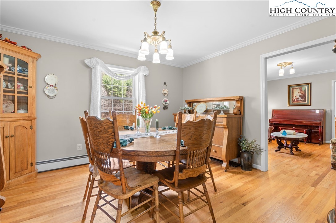 883 Bald Mountain Road West Jefferson, NC 28694 - Photo 8 of 47 a view of a dining room with furniture and wooden floor
