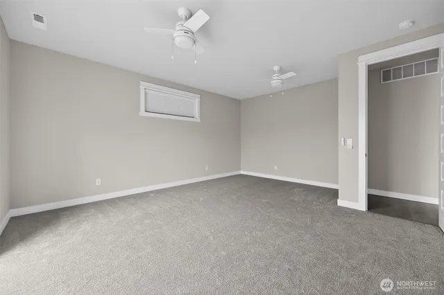 an empty room with windows and closet