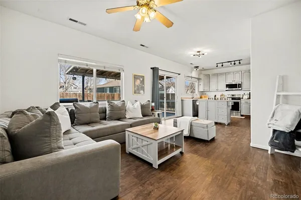 a living room with furniture and a chandelier