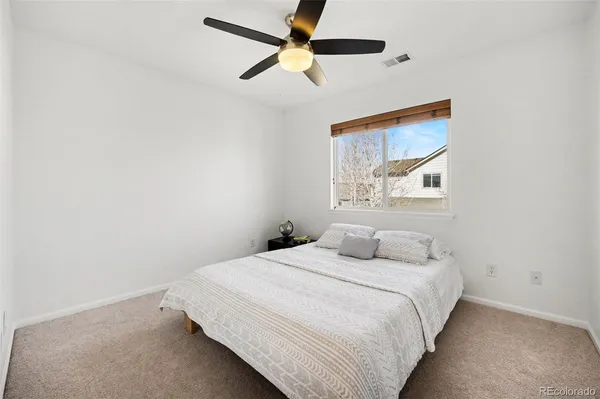 a bedroom with a bed and a painting on the wall