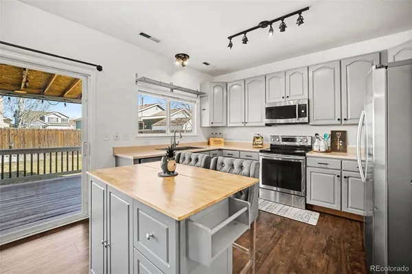 a kitchen with kitchen island a counter appliances cabinets and a counter top space