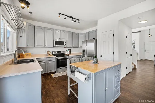 a kitchen with a sink stove and refrigerator