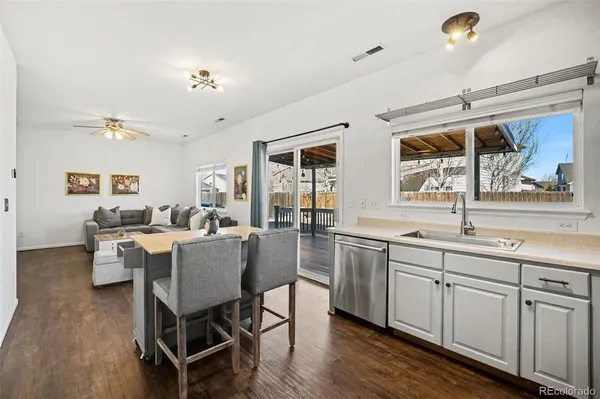 a view of a dining room with furniture a chandelier and wooden floor