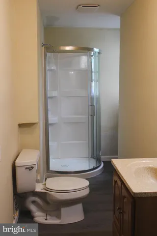 a bathroom with a toilet and a shower