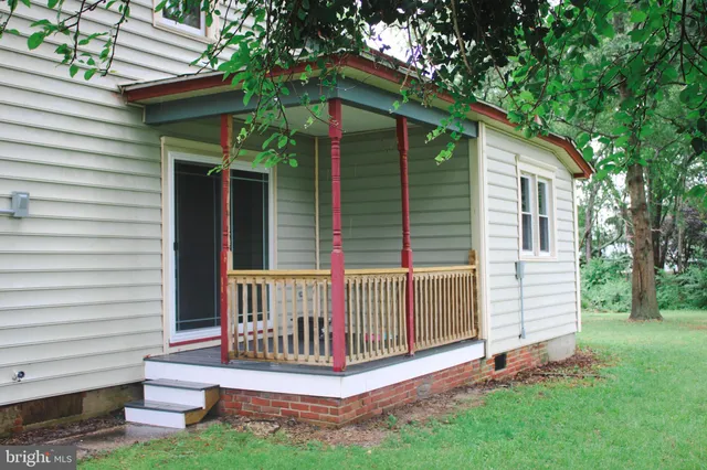 a view of a house with a yard and wooden fence