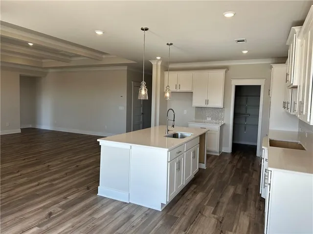 a bathroom with a double vanity sink a large mirror and a shower