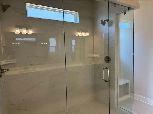 a view of a lake with a yard and large trees