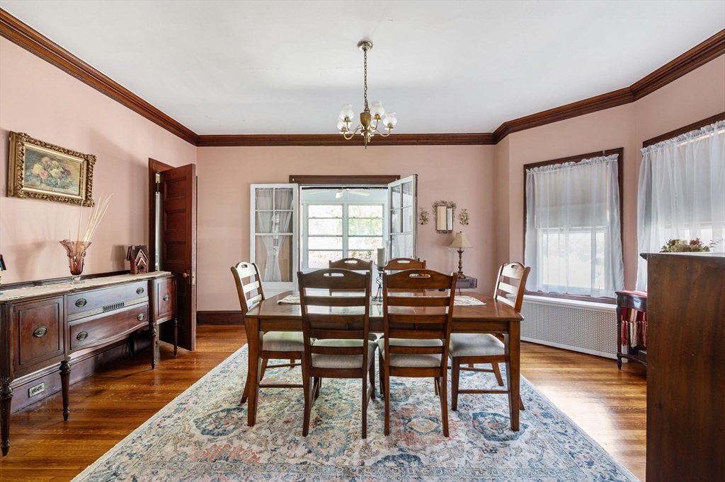16 Beaumont Street Boston, MA 02124 - Photo 15 of 41 a dining room with furniture a chandelier and wooden floor