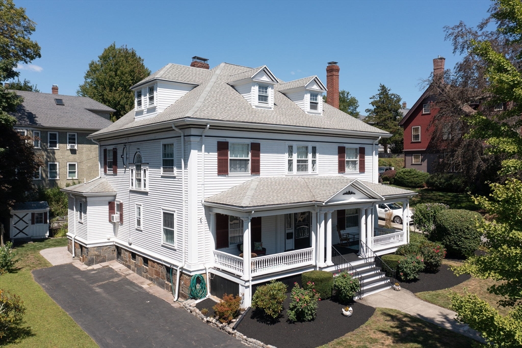 16 Beaumont Street Boston, MA 02124 - Photo 2 of 41 a view of a white house with a yard and potted plants