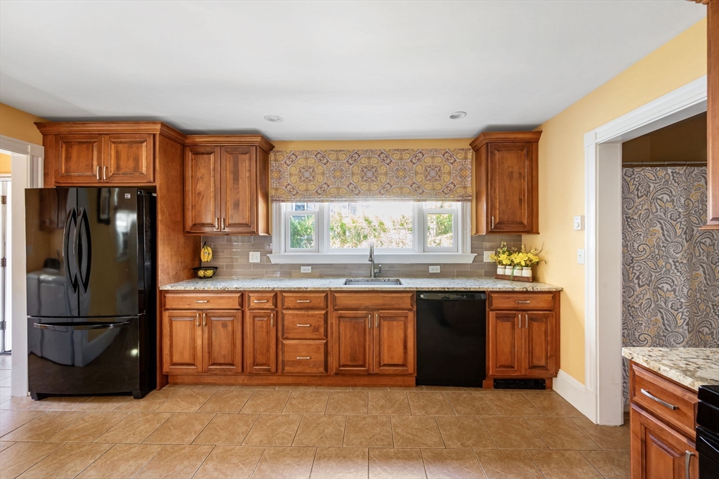 16 Beaumont Street Boston, MA 02124 - Photo 21 of 41 a kitchen with stainless steel appliances granite countertop a refrigerator a sink a stove and a refrigerator