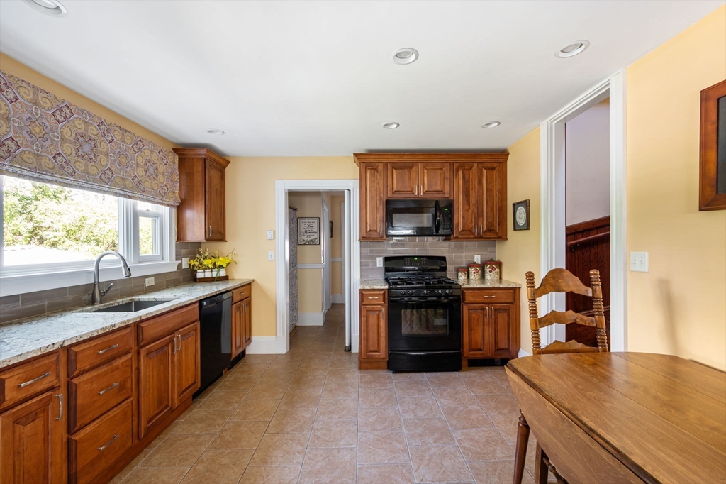 16 Beaumont Street Boston, MA 02124 - Photo 22 of 41 a kitchen with stainless steel appliances granite countertop a sink stove and refrigerator