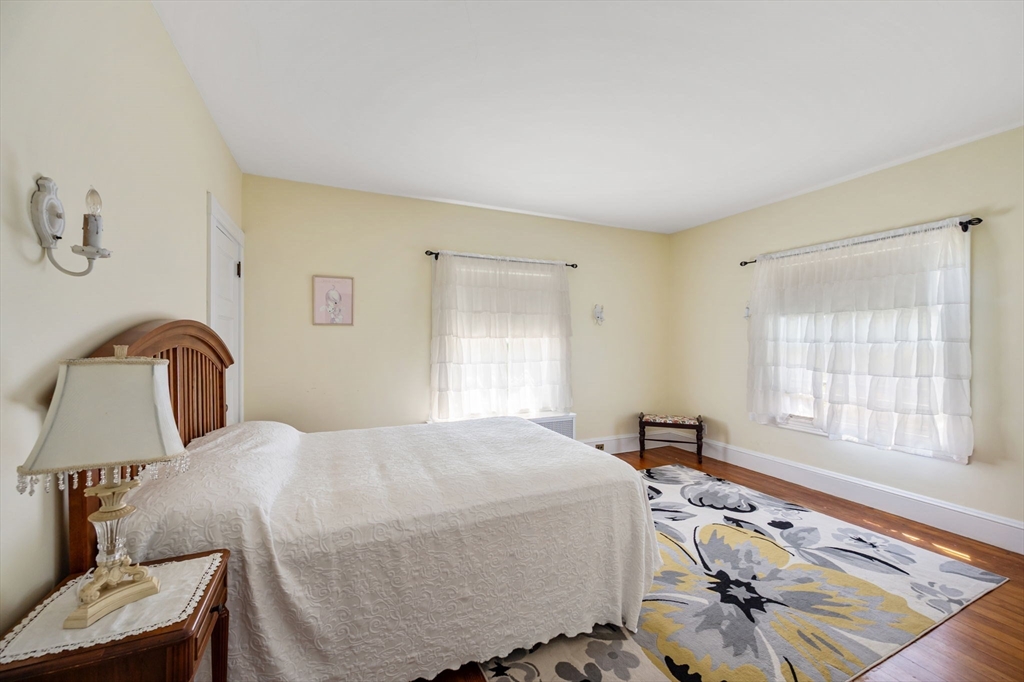 16 Beaumont Street Boston, MA 02124 - Photo 24 of 41 a bedroom with a bed and dresser with window