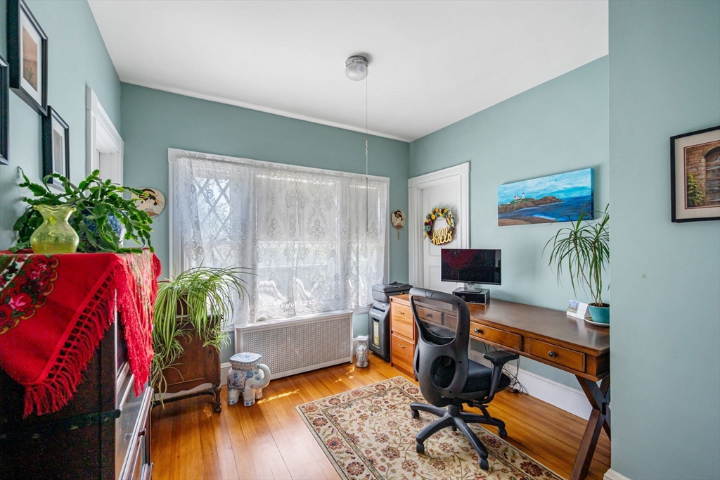 16 Beaumont Street Boston, MA 02124 - Photo 25 of 41 a view of a workspace with furniture and a potted plant