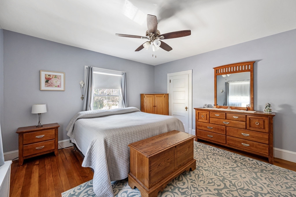 16 Beaumont Street Boston, MA 02124 - Photo 27 of 41 a bedroom with a bed and wooden floor