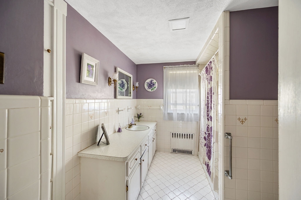 16 Beaumont Street Boston, MA 02124 - Photo 28 of 41 a bathroom with a sink and mirror