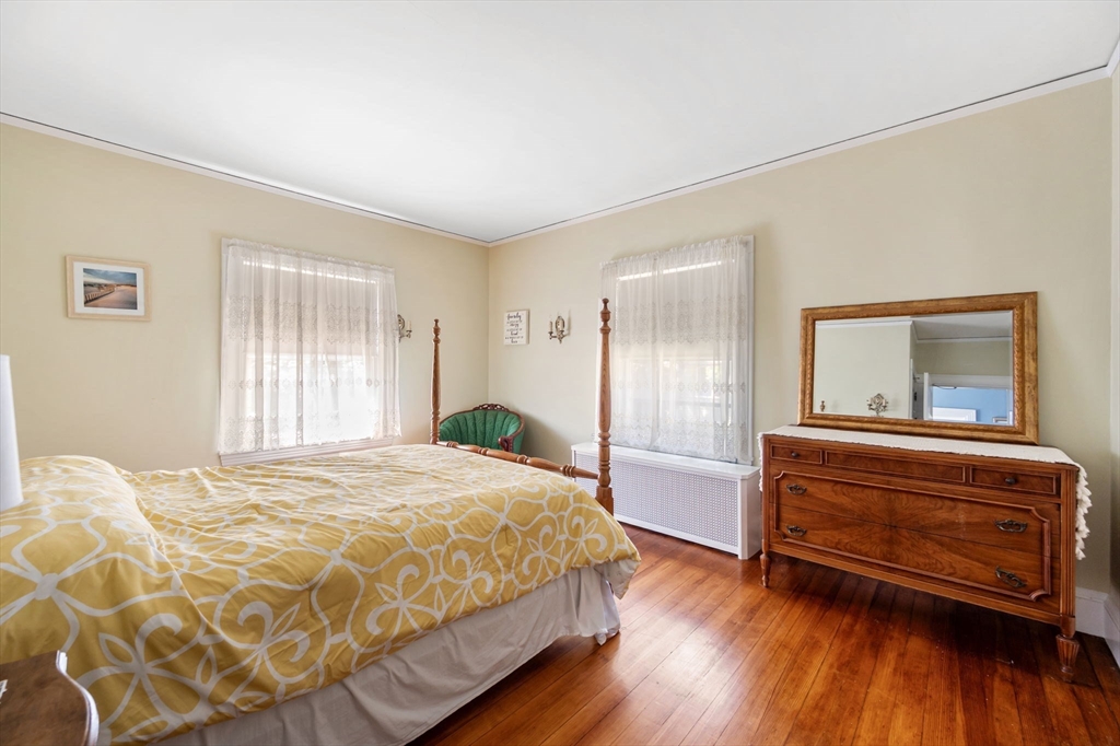 16 Beaumont Street Boston, MA 02124 - Photo 29 of 41 a bedroom with a bed and wooden floor