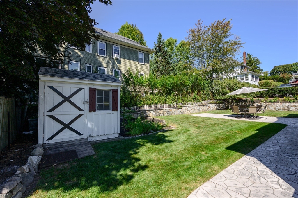 16 Beaumont Street Boston, MA 02124 - Photo 37 of 41 a view of house with garden space and trees