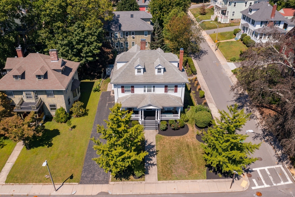 16 Beaumont Street Boston, MA 02124 - Photo 40 of 41 an aerial view of a house with a yard and large trees