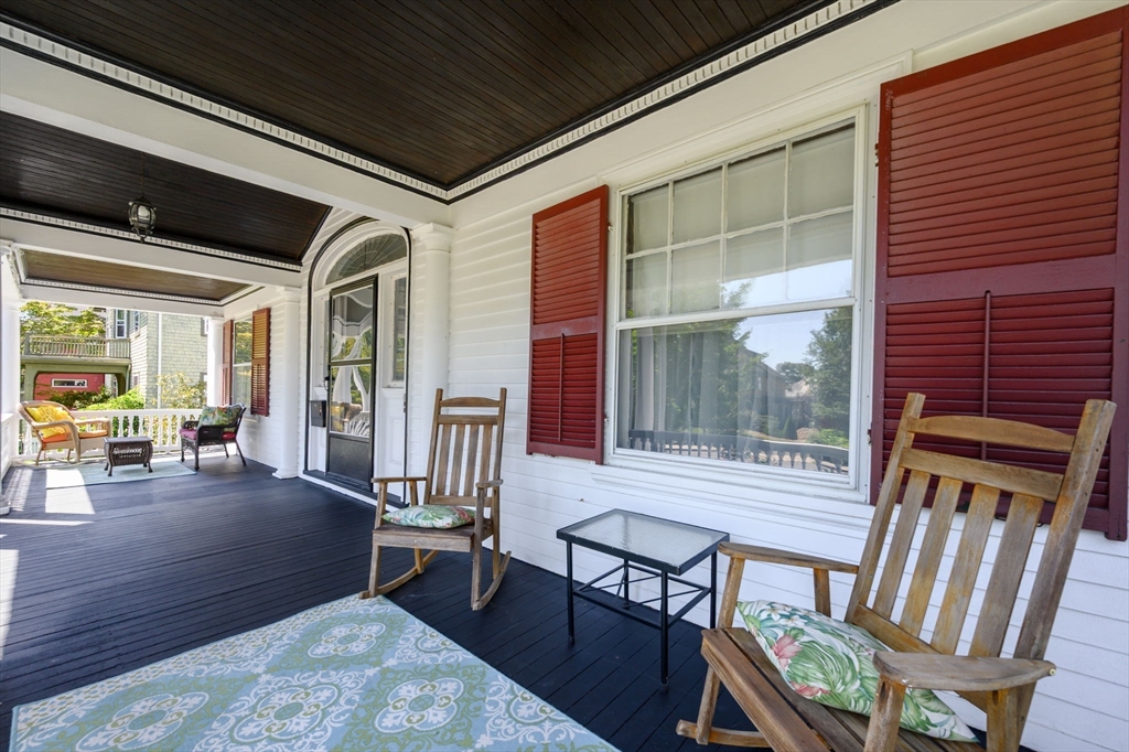 16 Beaumont Street Boston, MA 02124 - Photo 7 of 41 a porch area with table and chairs