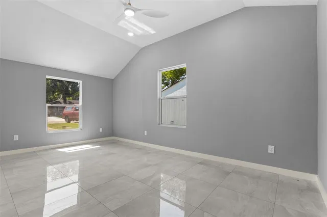 an empty room with windows and closet