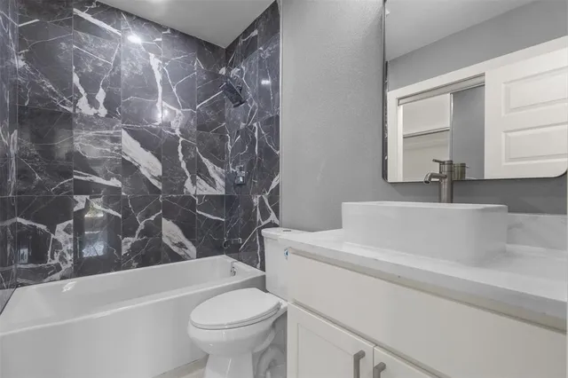 a bathroom with a sink a toilet and a bathtub