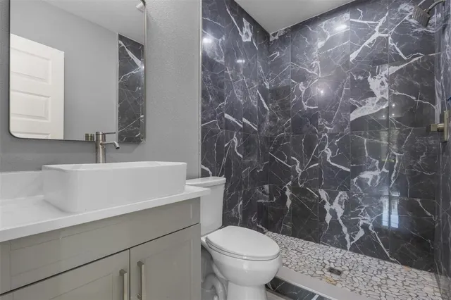 a bathroom with a sink toilet and shower