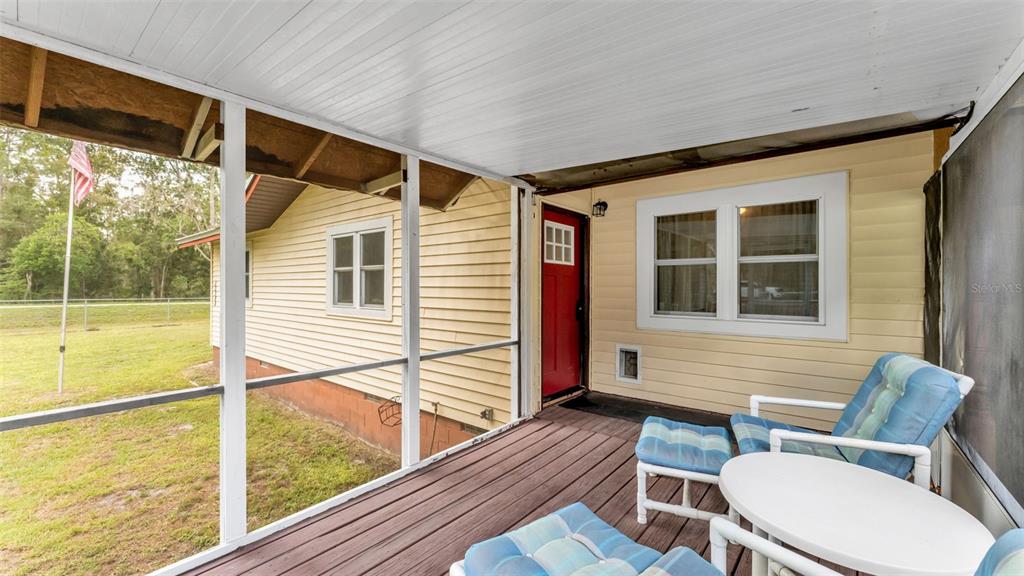 13700 Pine Meadow Road Kathleen, FL 33849 - Photo 11 of 39 a view of a chairs and table in the balcony