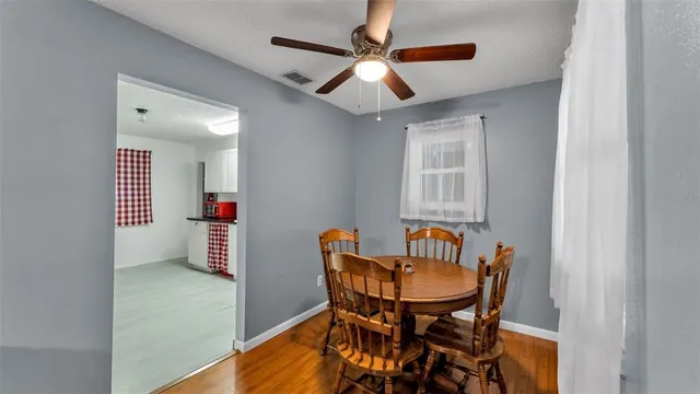 a view of a room with furniture and wooden floor