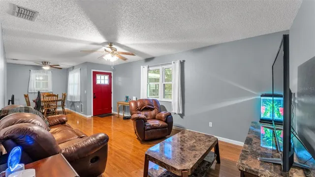 a living room with furniture a fireplace and a window