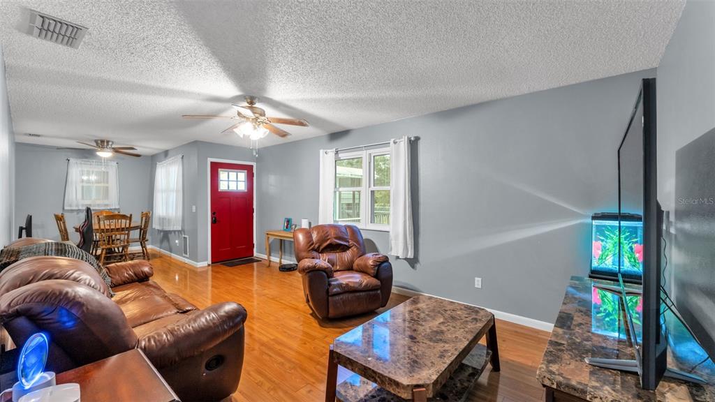 13700 Pine Meadow Road Kathleen, FL 33849 - Photo 17 of 39 a living room with furniture a fireplace and a window