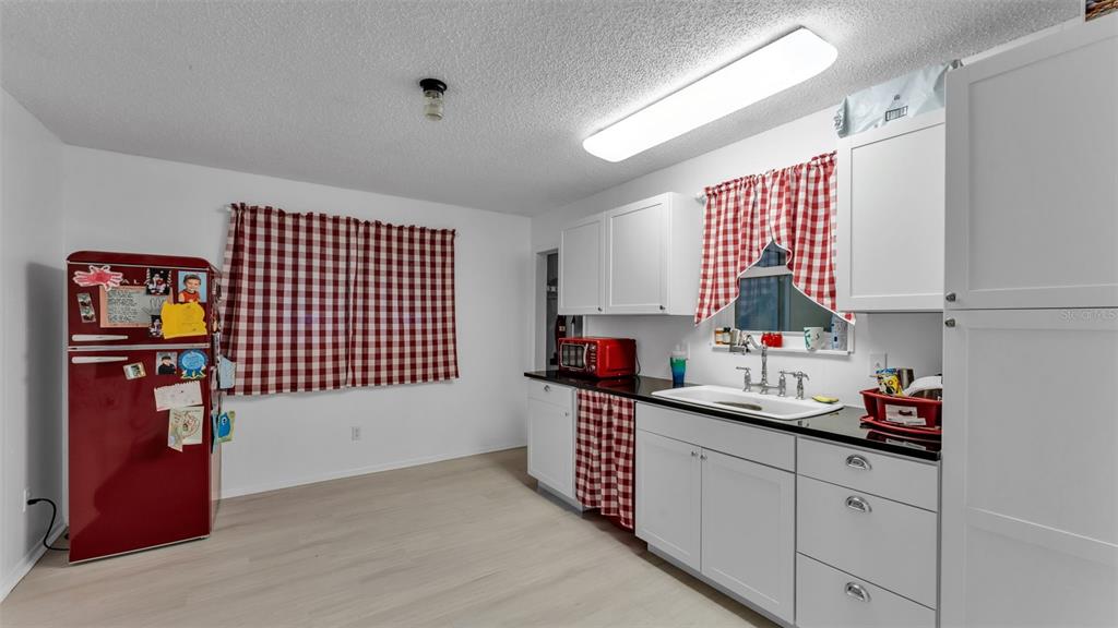 13700 Pine Meadow Road Kathleen, FL 33849 - Photo 18 of 39 a kitchen with stainless steel appliances cabinets a sink and a window