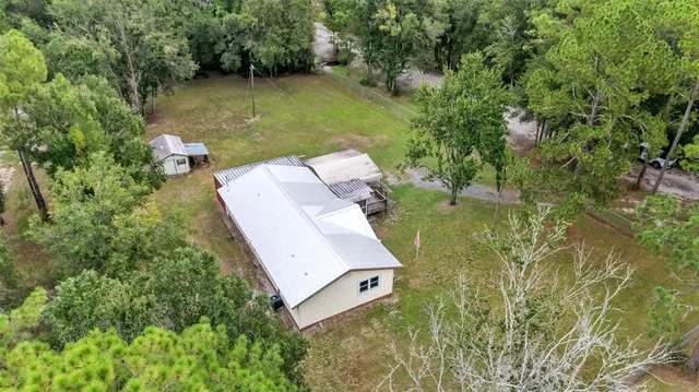 an aerial view of a house with a yard