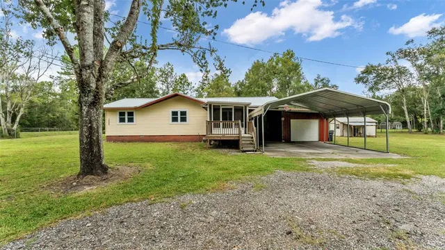 a view of a house with a yard and sitting area