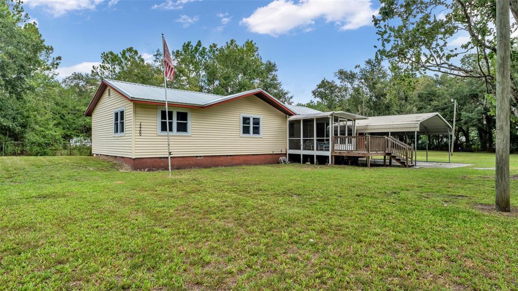 13700 Pine Meadow Road Kathleen, FL 33849 - Photo 9 of 39 a view of a house with backyard and garden