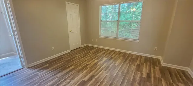 a view of a room with wooden floor and windows