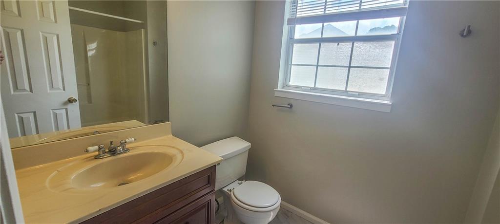 2120 Fairways Court Kennesaw, GA 30144 - Photo 13 of 20 a bathroom with a granite countertop sink toilet and a mirror