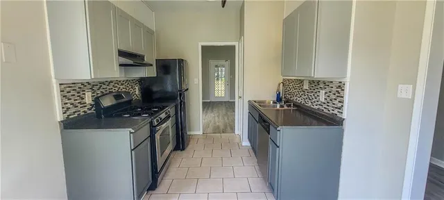 a kitchen with granite countertop a sink and a stove