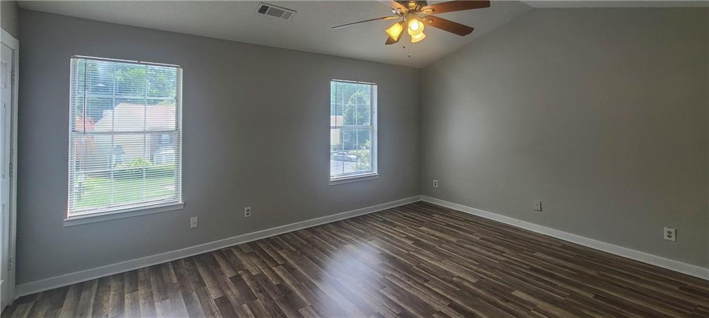 2120 Fairways Court Kennesaw, GA 30144 - Photo 8 of 20 an empty room with wooden floor and windows
