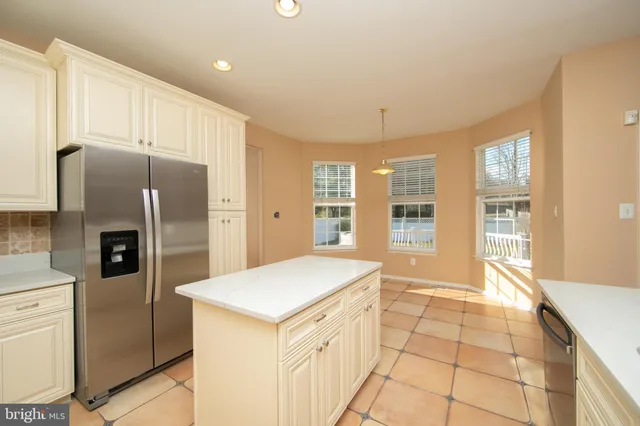 a kitchen with stainless steel appliances a refrigerator and a sink