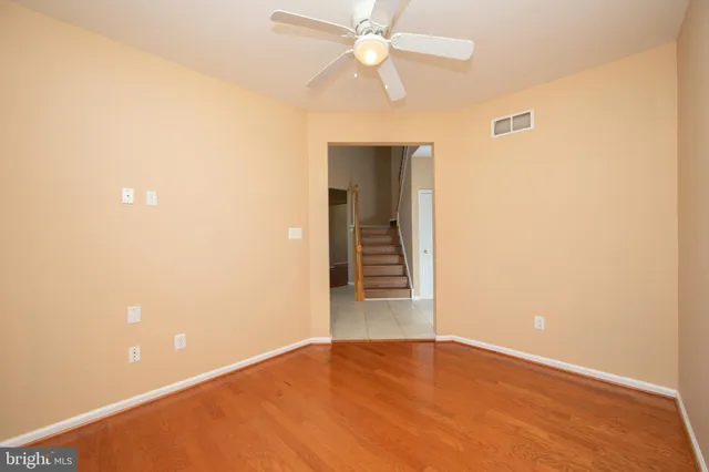 a view of an empty room with a ceiling fan