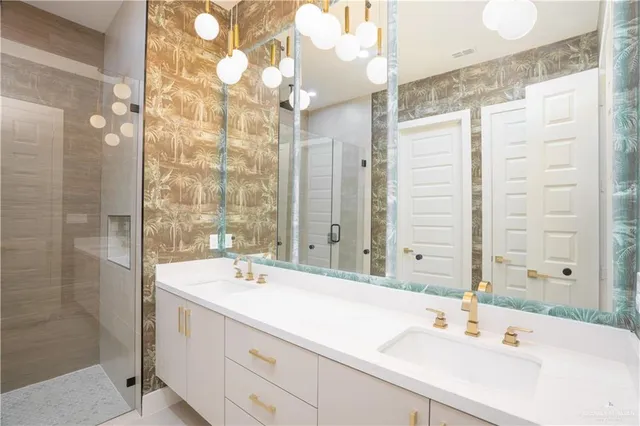 a bathroom with a double vanity sink mirror and shower